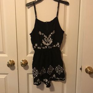 Never worn black romper with white flower design